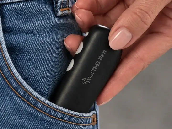 Slipping the yourTMJ Pen into a jeans pocket