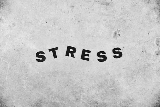 Black and white background of Stress title with bold letters on gray wall with rugged surface